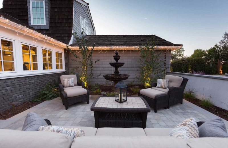 An outdoor patio with couch and chairs