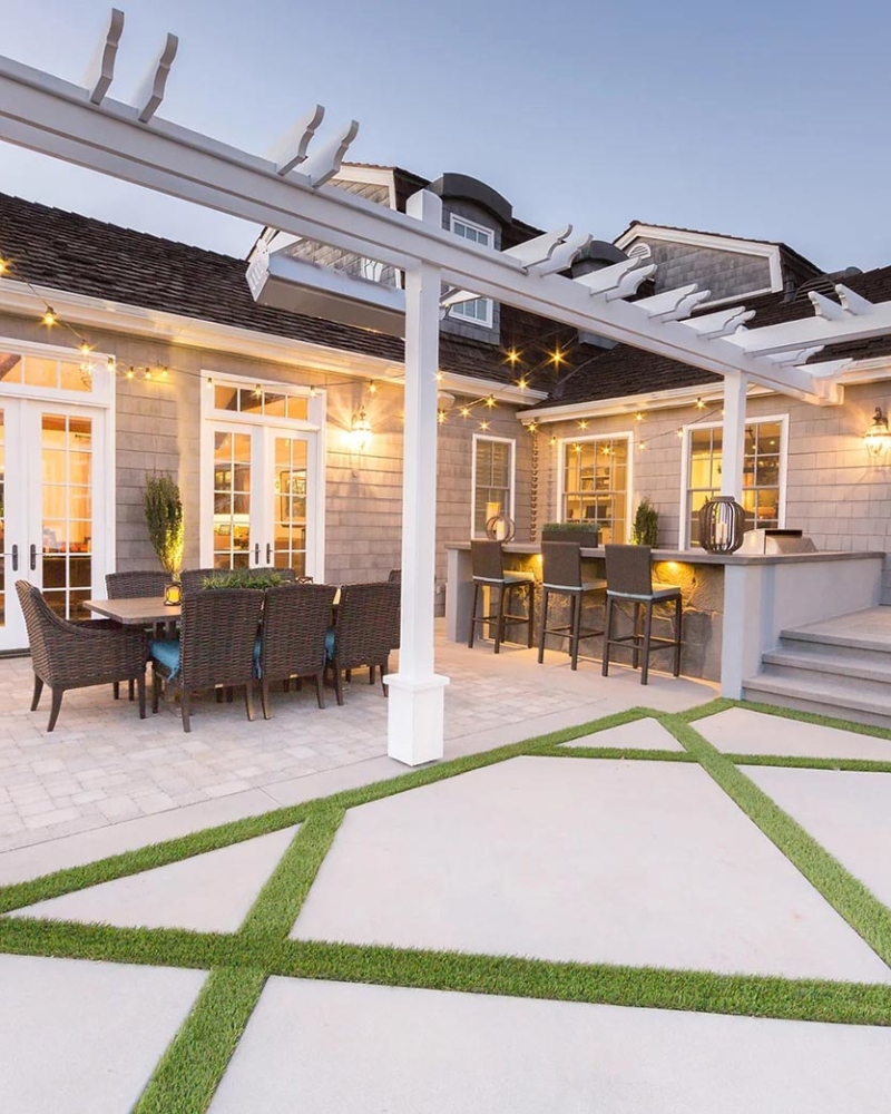 Backyard bar and tables with geometric turf stripes