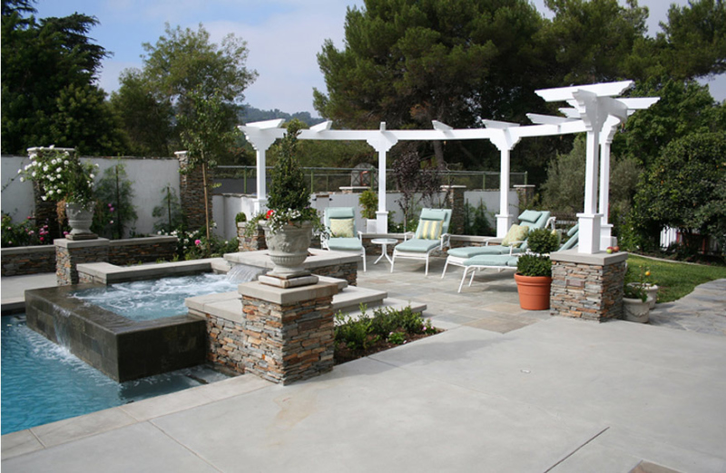 Backyard uncovered patio with chairs and pool