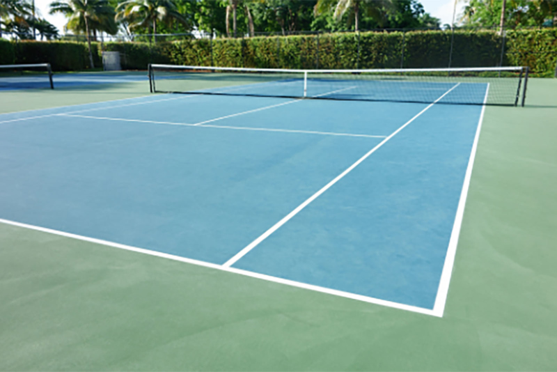 A green and blue tennis court