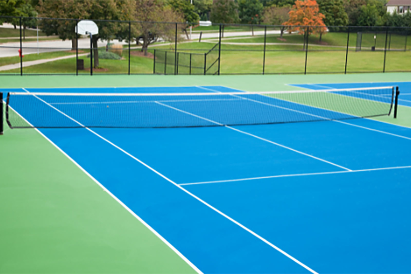 A green and blue tennis court