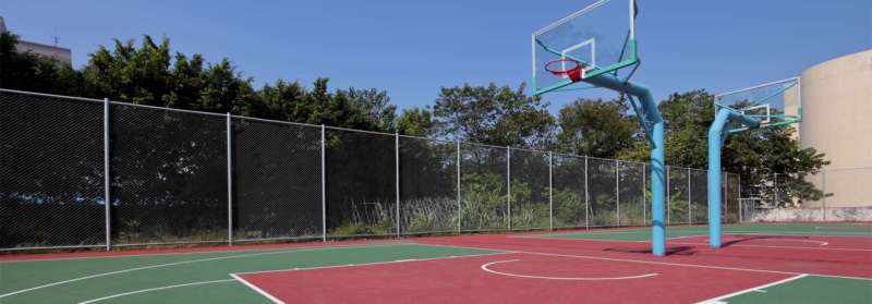 A basketball hoop surrounded by a fence
