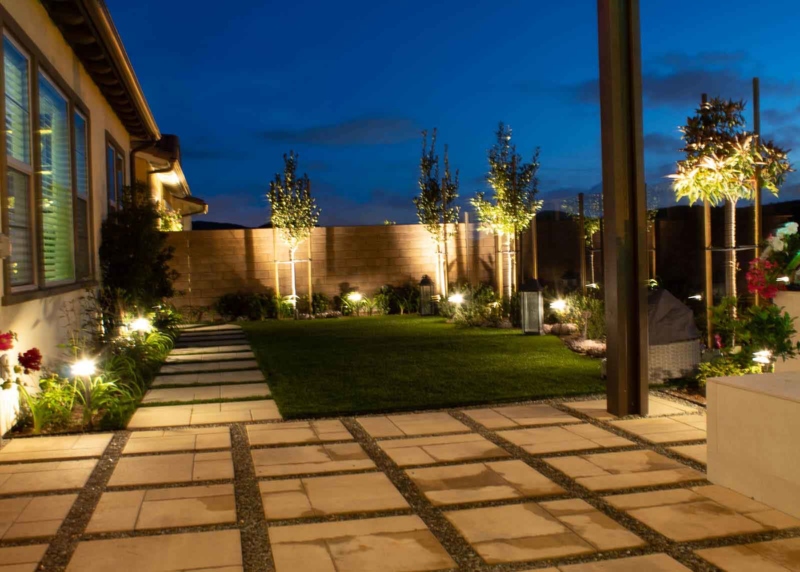 A backyard with lights and walkway